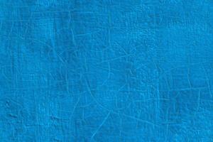 thick fresh blue oil paint on flat steel surface seamless texture with old cracks under it photo