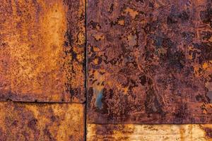 Rusted flat composite nailed metal sheets surface background and texture. photo
