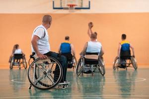 a photo of basketball teams with disabilities with the selector in the big hall before the start of the basketball game