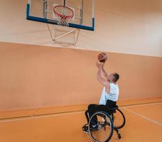 a cameraman with professional equipment records a match of the national team in a wheelchair playing a match in the arena photo