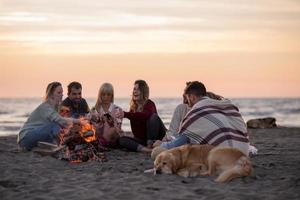 Friends having fun at beach on autumn day photo