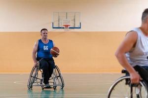 disabled war veterans in action while playing basketball on a basketball court with professional sports equipment for the disabled photo