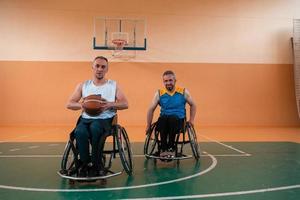 disabled war veterans in action while playing basketball on a basketball court with professional sports equipment for the disabled photo