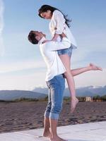 young couple  on beach have fun photo