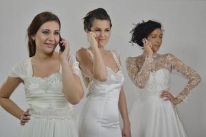 portrait of a three beautiful woman in wedding dress photo