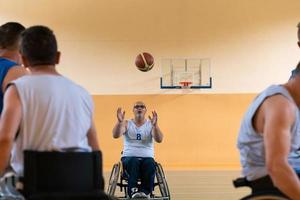 disabled war veterans in action while playing basketball on a basketball court with professional sports equipment for the disabled photo