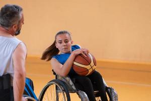 a young woman playing wheelchair basketball in a professional team. Gender equality, the concept of sports with disabilities. photo