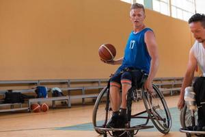 disabled war veterans in action while playing basketball on a basketball court with professional sports equipment for the disabled photo