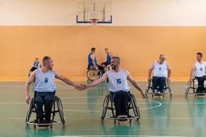 a team of war veterans in wheelchairs playing basketball, celebrating points won in a game. High five concept photo