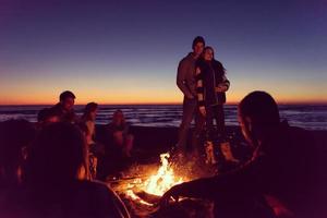 Friends having fun at beach on autumn day photo