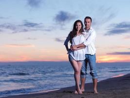 young couple  on beach have fun photo