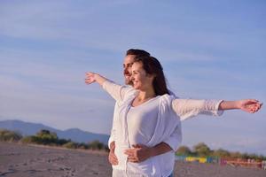 young couple  on beach have fun photo