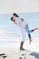 happy young couple have fun at beautiful beach photo