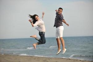 happy young couple have fun on beach photo