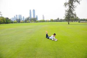 woman with laptop in park photo