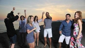 Group of young people enjoy summer  party at the beach photo