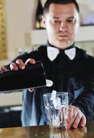 pro barman prepare coctail drink on party photo