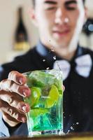 pro barman prepare coctail drink on party photo