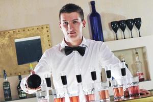 pro barman prepare coctail drink on party photo