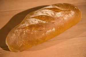 fresh bread on wooden table photo