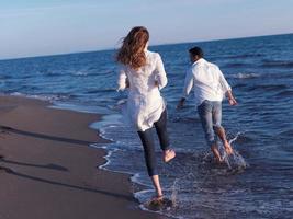 young couple  on beach have fun photo