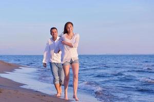 young couple  on beach have fun photo