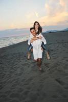 happy young couple have fun on beach photo