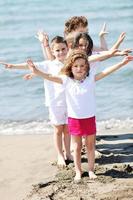 happy child group playing  on beach photo