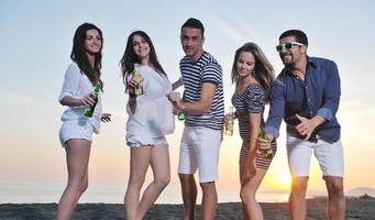 Group of young people enjoy summer  party at the beach photo