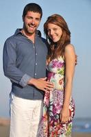 happy young couple have romantic time on beach photo