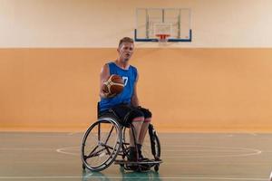 disabled war veterans in action while playing basketball on a basketball court with professional sports equipment for the disabled photo