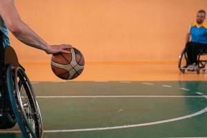 Close up photo of wheelchairs and handicapped war veterans playing basketball on the court