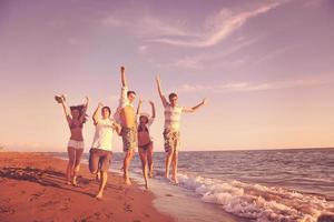 people group running on the beach photo