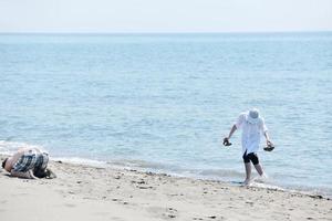 happy young couple have fun on beach photo