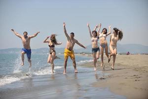 happy people group have fun and running on beach photo