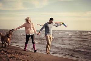 happy couple enjoying time together at beach photo
