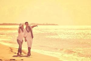 feliz pareja joven divertirse en la hermosa playa foto