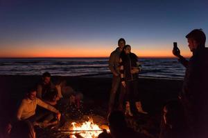 Friends having fun at beach on autumn day photo