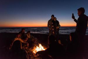 Friends having fun at beach on autumn day photo