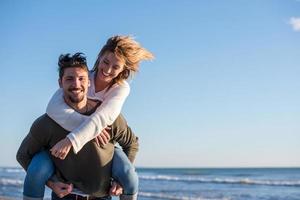 couple having fun at beach during autumn photo