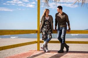 Couple chating and having fun at beach bar photo