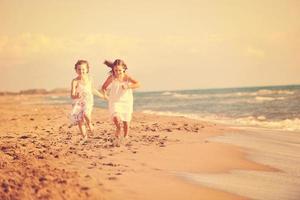 cute little girls running on beach photo