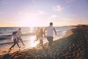 people group running on the beach photo