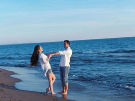 young couple  on beach have fun photo