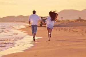 young couple  on beach have fun photo