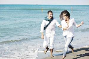 happy young couple have fun at beautiful beach photo