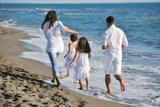 happy young  family have fun on beach photo
