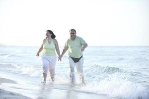 happy seniors couple  on beach photo