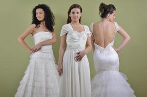 portrait of a three beautiful woman in wedding dress photo