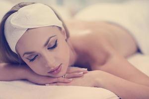 woman getting back massage in spa salon photo